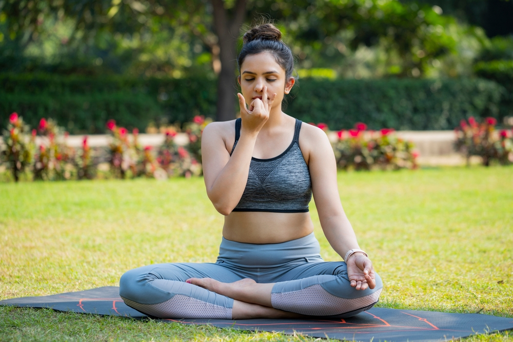 girl doing pranayama in yoga suit in Garden in the morning